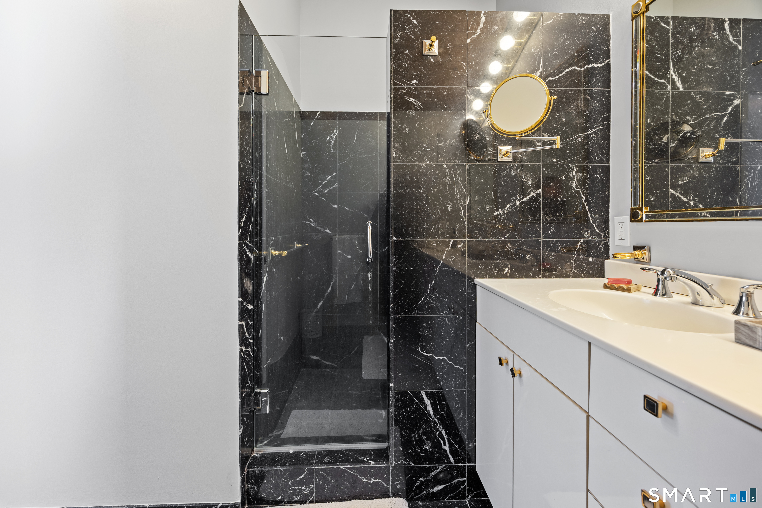 305 Westledge Drive Torrington, CT 06790 - Photo 21 of 37 a bathroom with a mirror sink and glass door shower