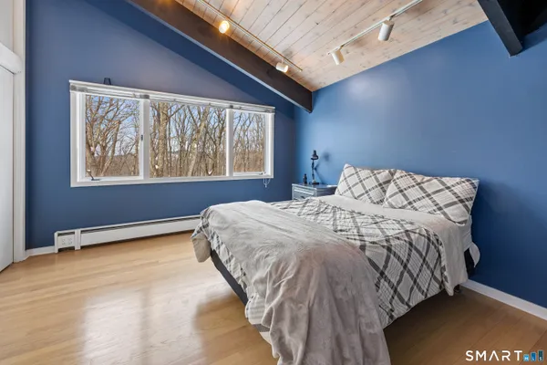 a bedroom with a bed and window