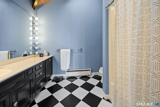 a bathroom with a double vanity sink and mirror