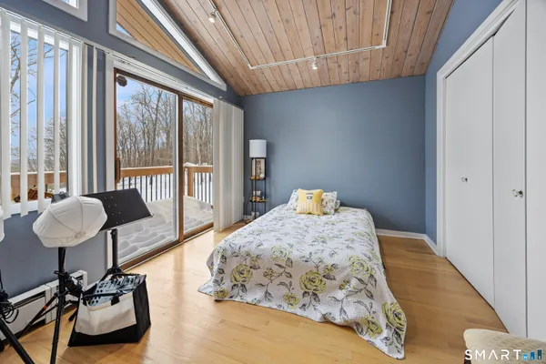 a bedroom with furniture and a large window