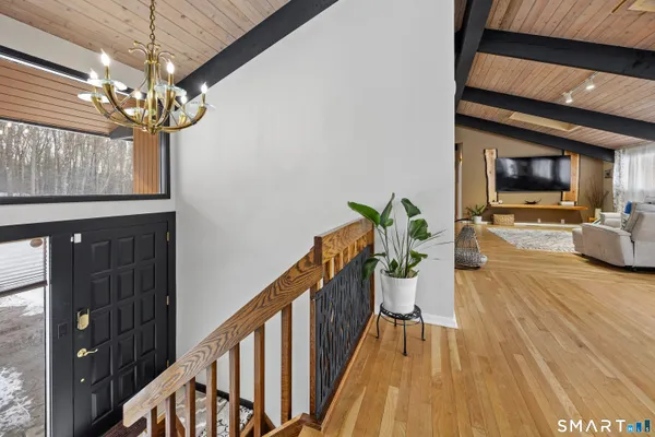 a view of a dining room with furniture wooden floor and chandelier