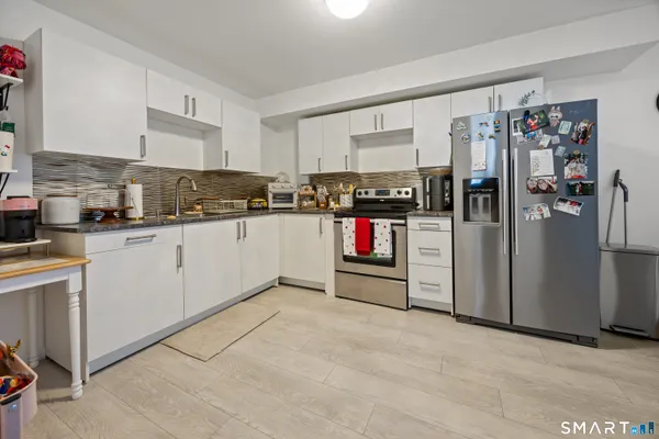 a kitchen with refrigerator and cabinets