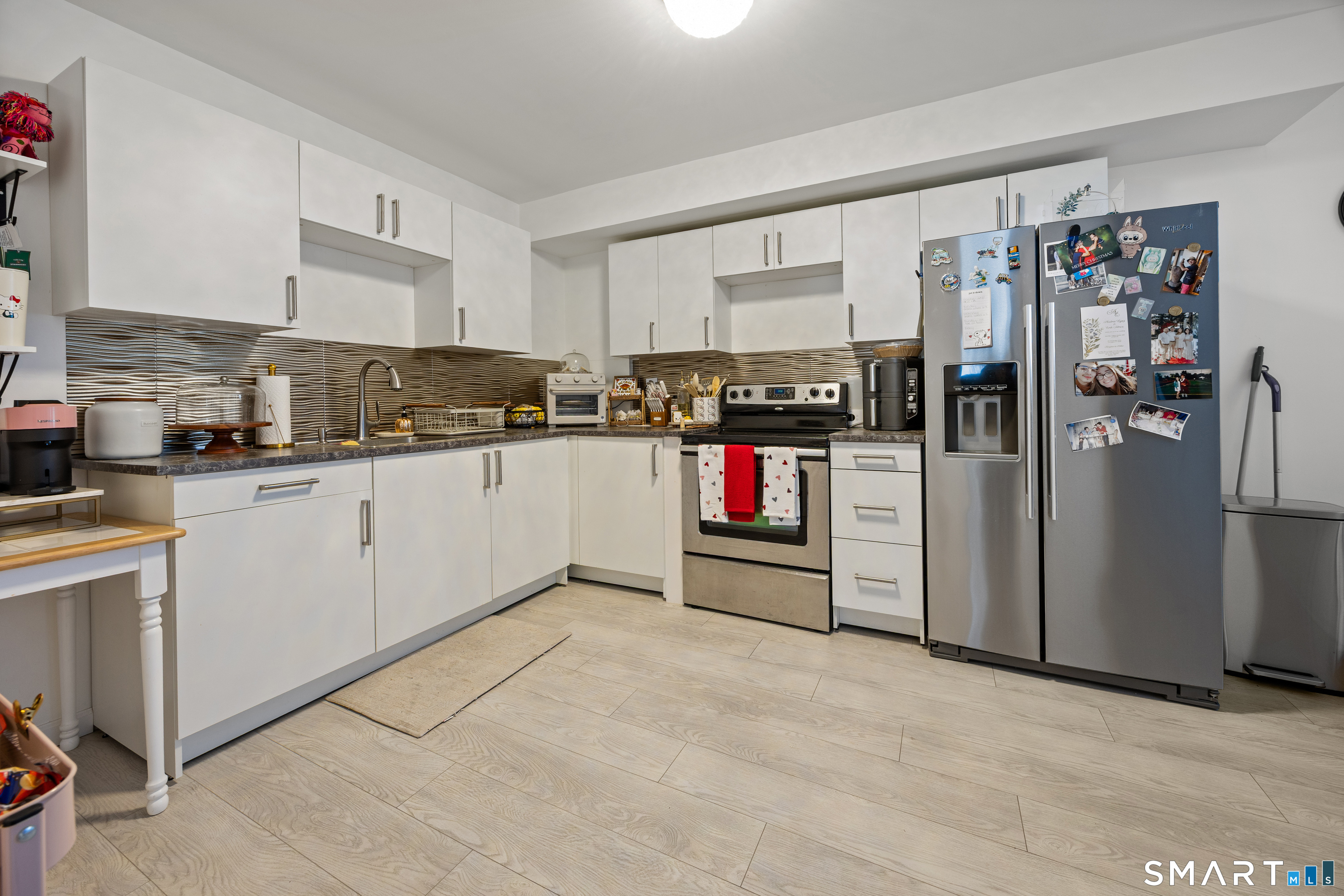 305 Westledge Drive Torrington, CT 06790 - Photo 30 of 37 a kitchen with refrigerator and cabinets