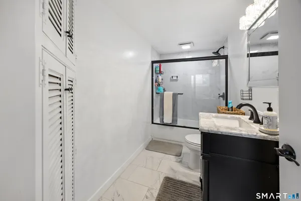 a bathroom with a sink a mirror and shower