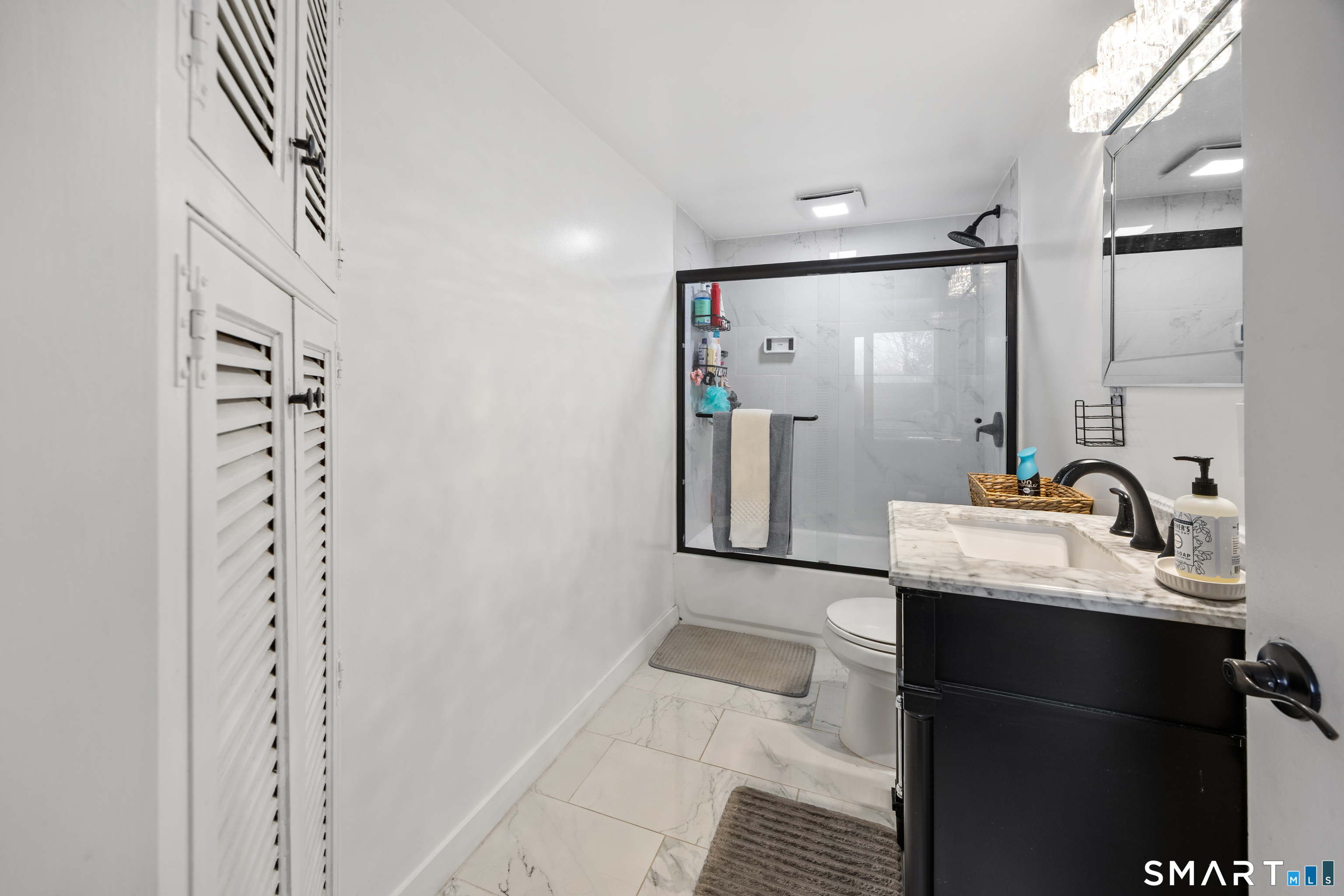 305 Westledge Drive Torrington, CT 06790 - Photo 34 of 37 a bathroom with a sink a mirror and shower