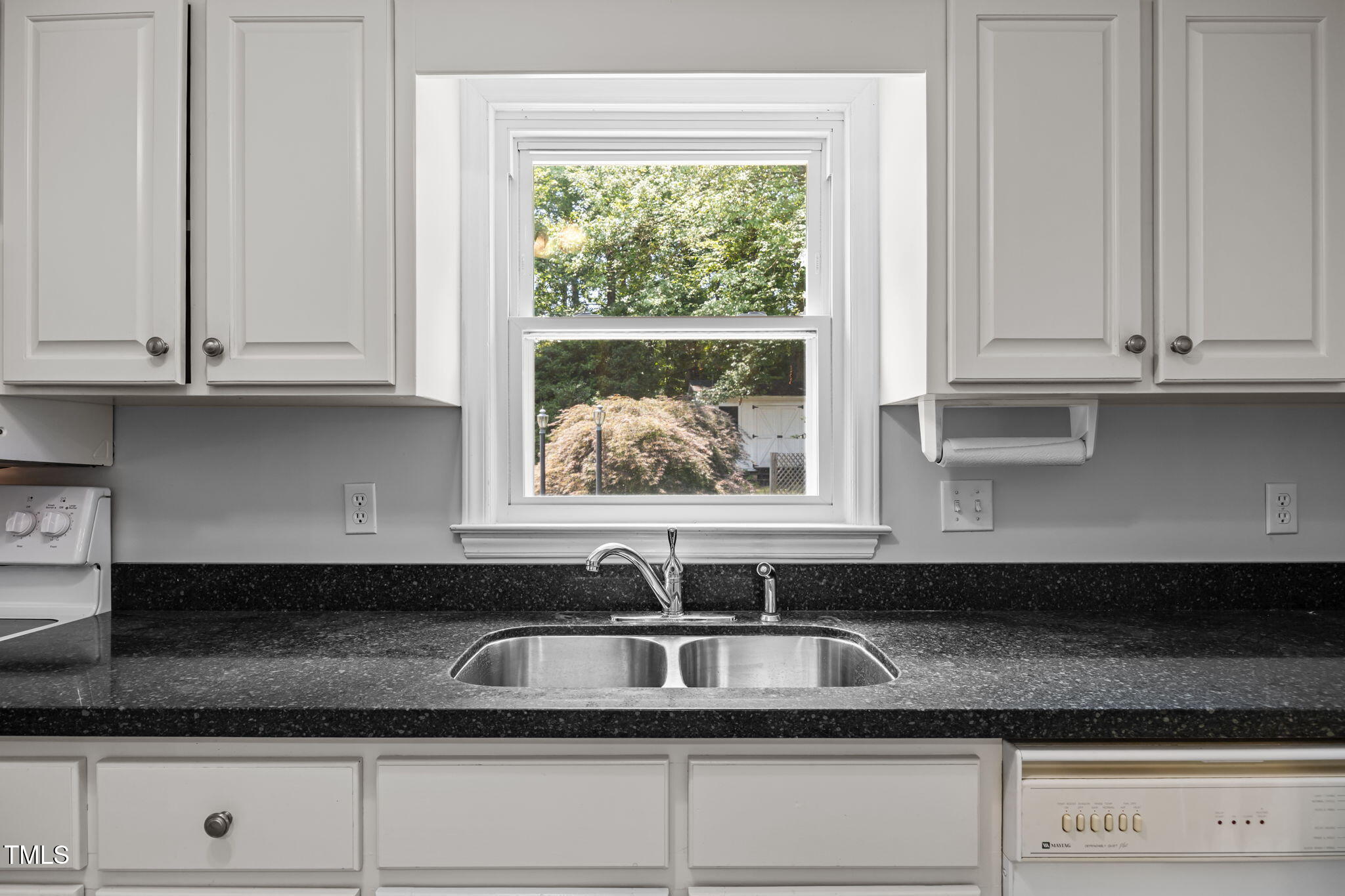 8909 Creekstone Court, Unit 11 Raleigh, NC 27615 - Photo 11 of 39 a sink with white cabinets and a granite counter top