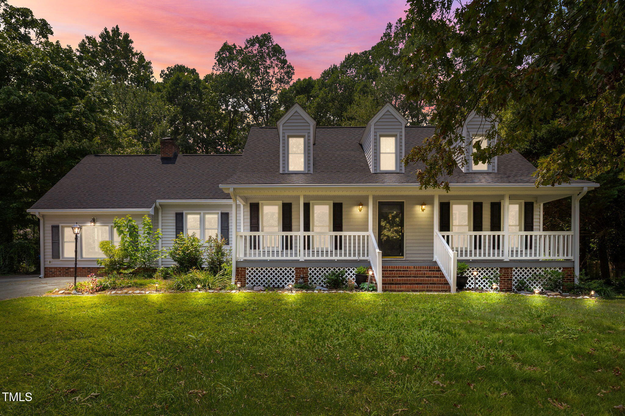 8909 Creekstone Court, Unit 11 Raleigh, NC 27615 - Photo 2 of 39 a front view of a house with a yard and potted plants