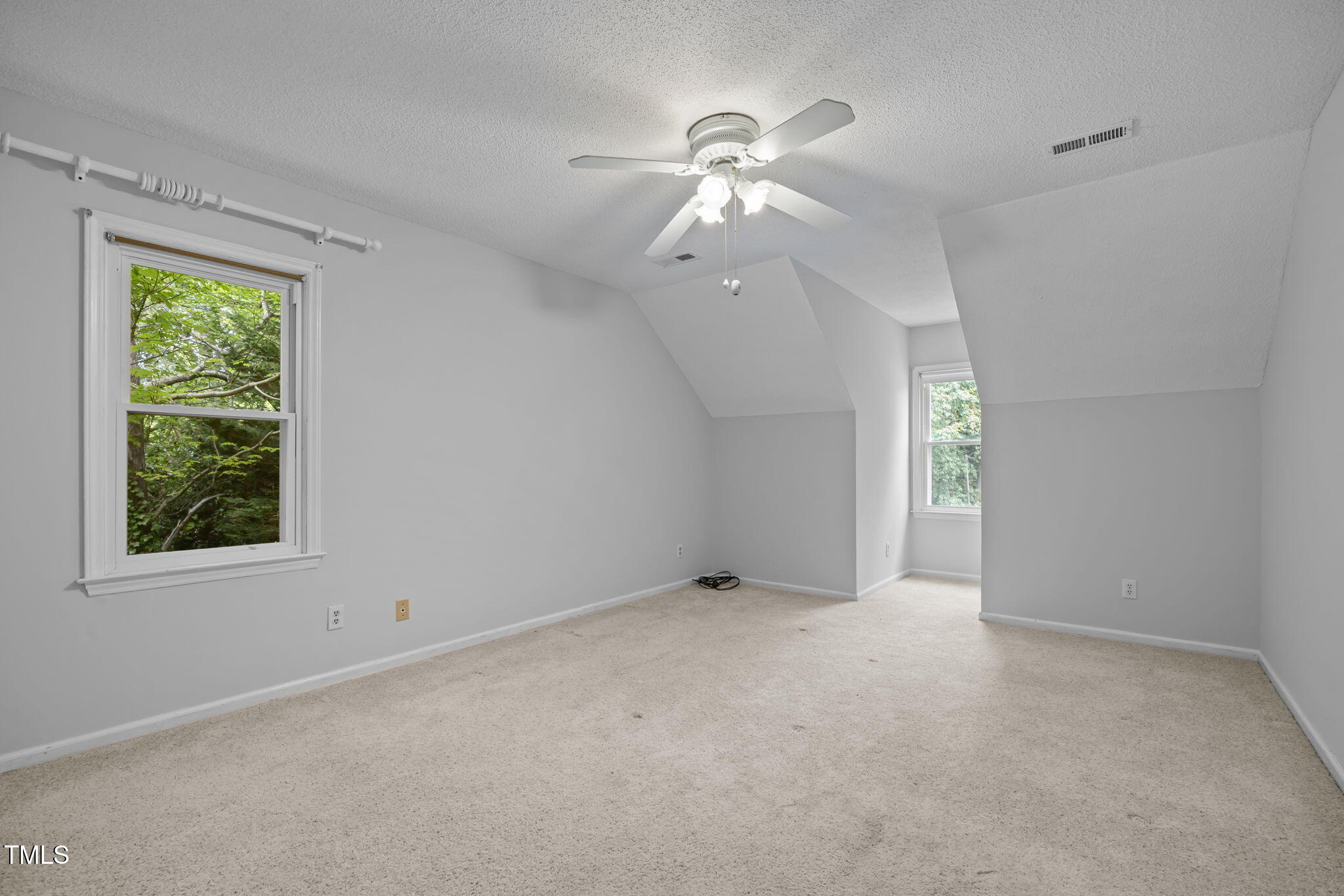 8909 Creekstone Court, Unit 11 Raleigh, NC 27615 - Photo 24 of 39 an empty room with windows and chandelier fan