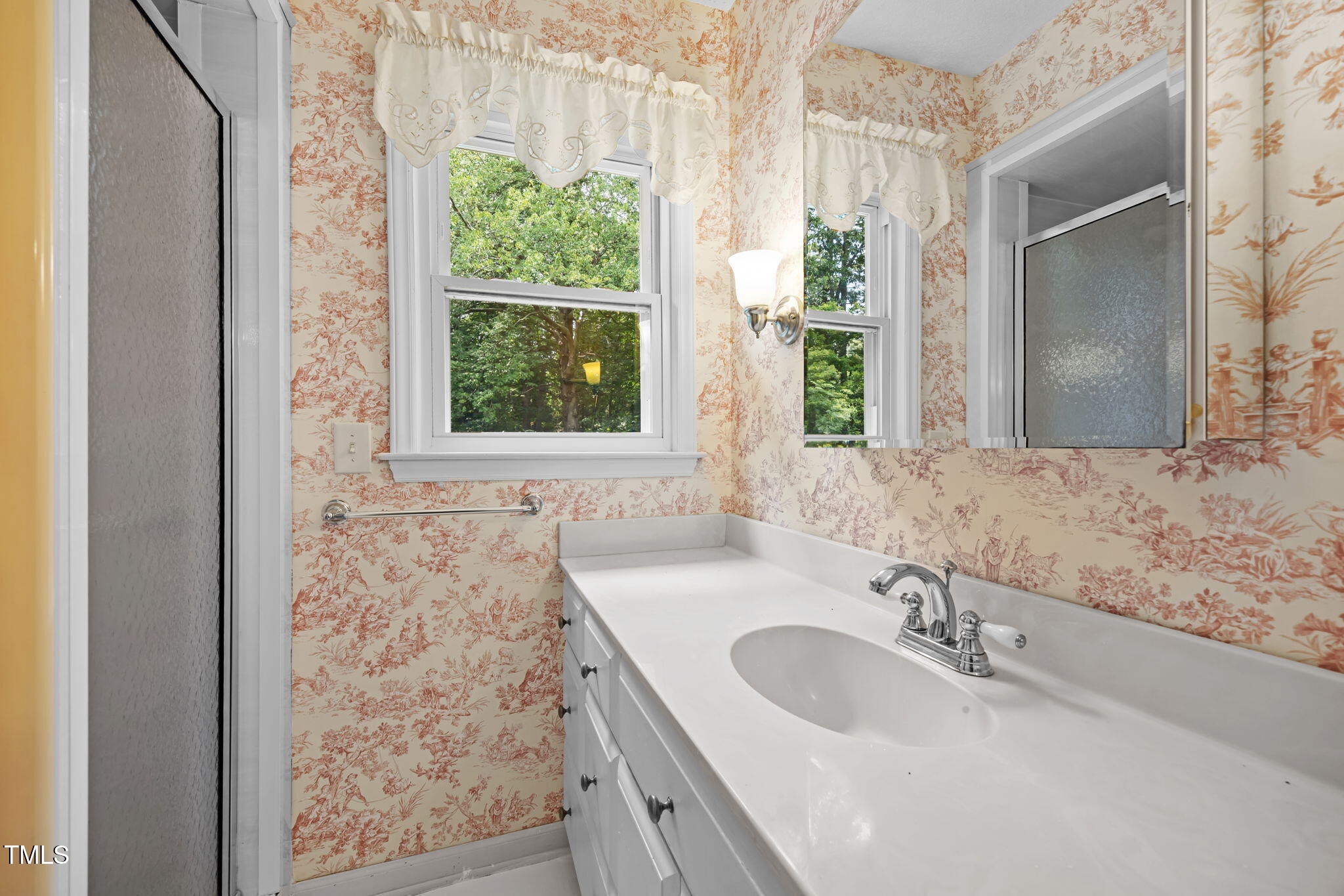 8909 Creekstone Court, Unit 11 Raleigh, NC 27615 - Photo 25 of 39 a bathroom with a granite countertop sink and a large mirror