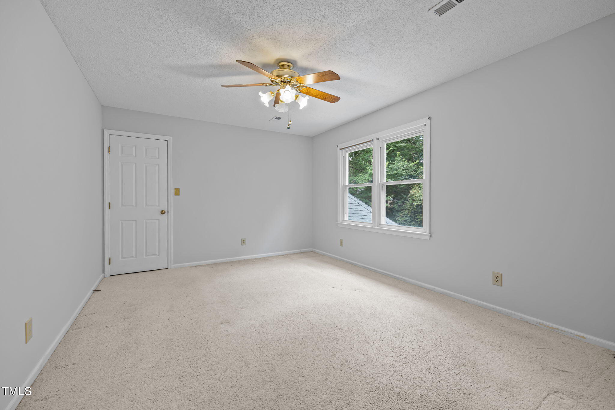 8909 Creekstone Court, Unit 11 Raleigh, NC 27615 - Photo 26 of 39 an empty room with windows and chandelier fan