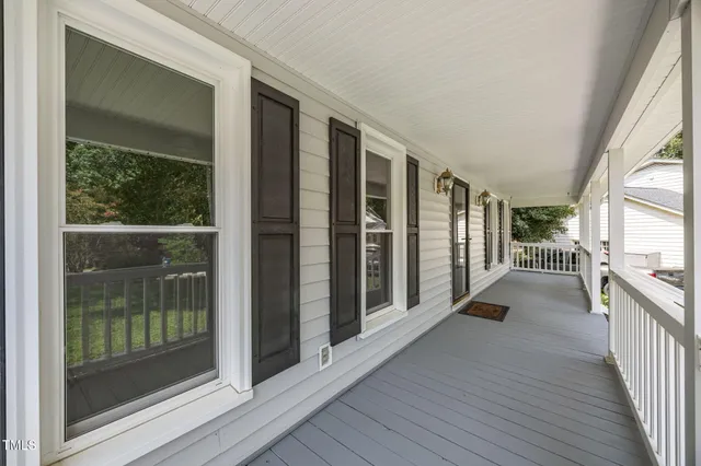 an aerial view of a house with a yard and trees
