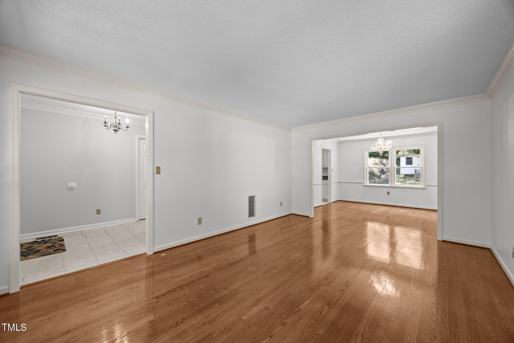 8909 Creekstone Court, Unit 11 Raleigh, NC 27615 - Photo 6 of 39 an empty room with wooden floor and windows