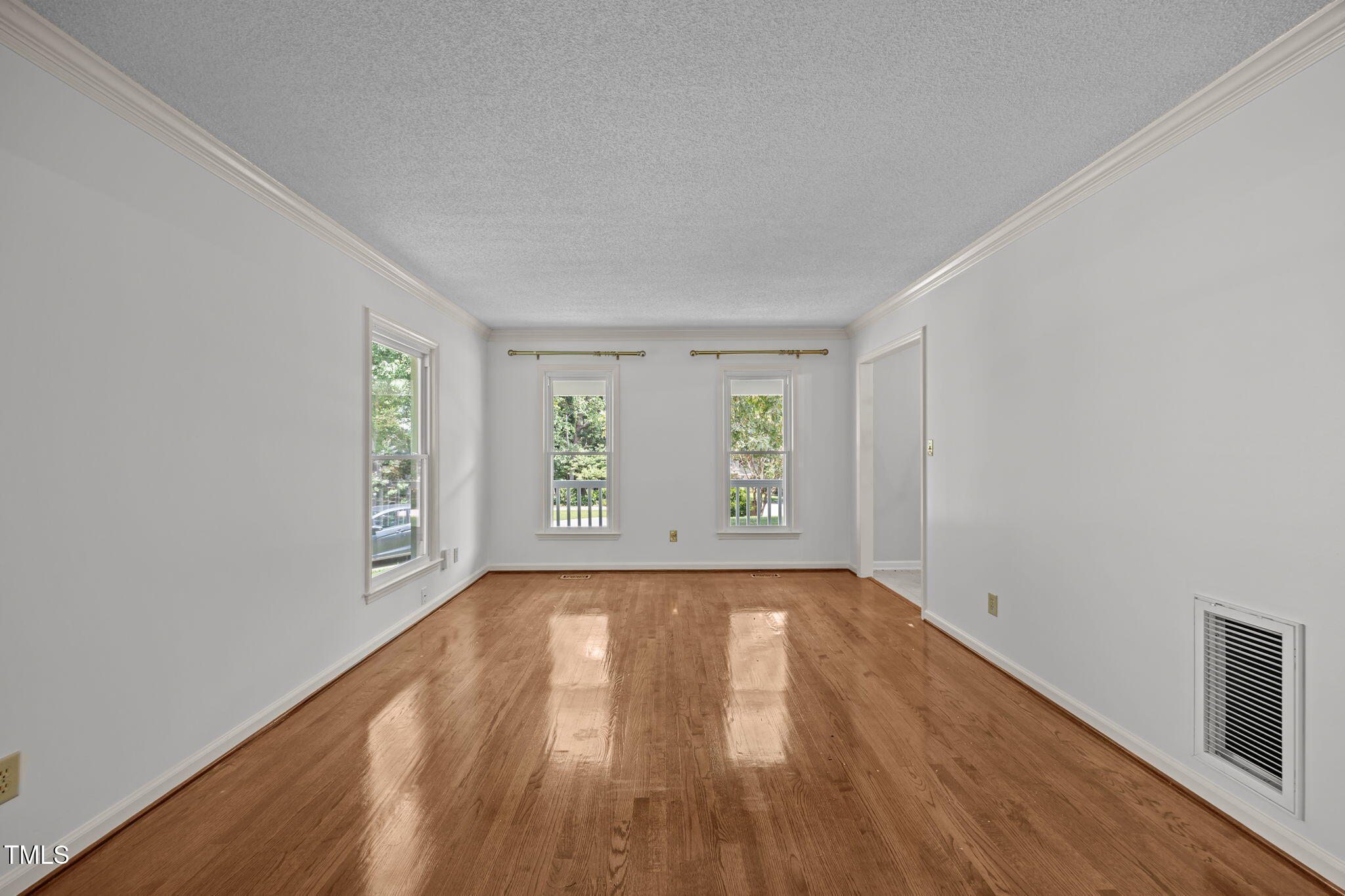 8909 Creekstone Court, Unit 11 Raleigh, NC 27615 - Photo 7 of 39 an empty room with wooden floor and windows