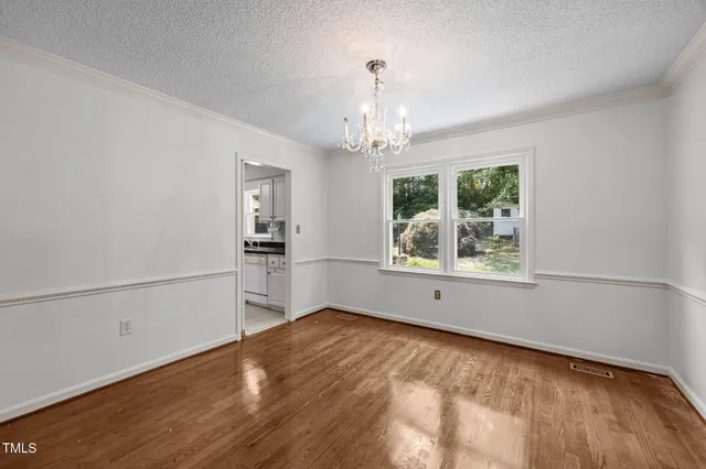 a kitchen with stainless steel appliances granite countertop a sink and dishwasher with white cabinets