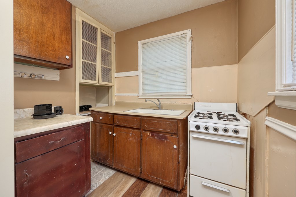 1641 16th Avenue Columbus, GA 31901 - Photo 13 of 76 a kitchen with a stove sink and cabinets
