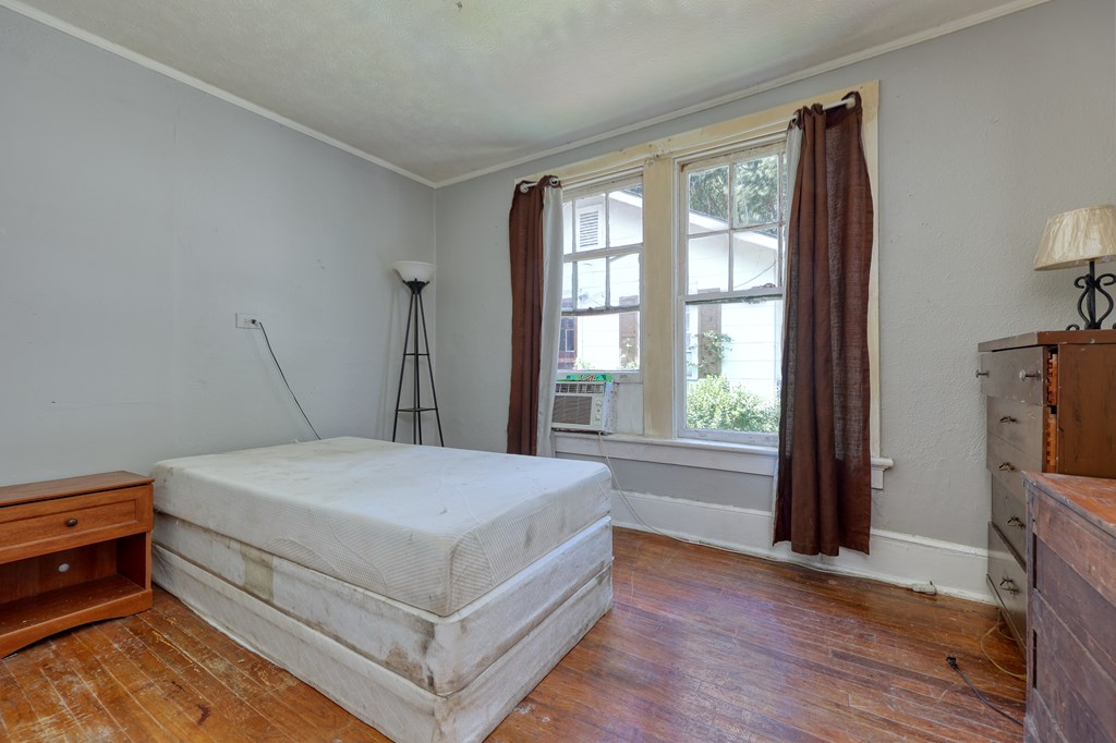 1641 16th Avenue Columbus, GA 31901 - Photo 23 of 76 a bedroom with a bed and a tv on the dresser