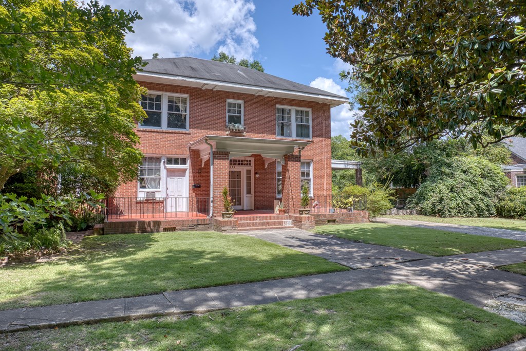 1641 16th Avenue Columbus, GA 31901 - Photo 28 of 76 a view of a brick house with a yard and large trees