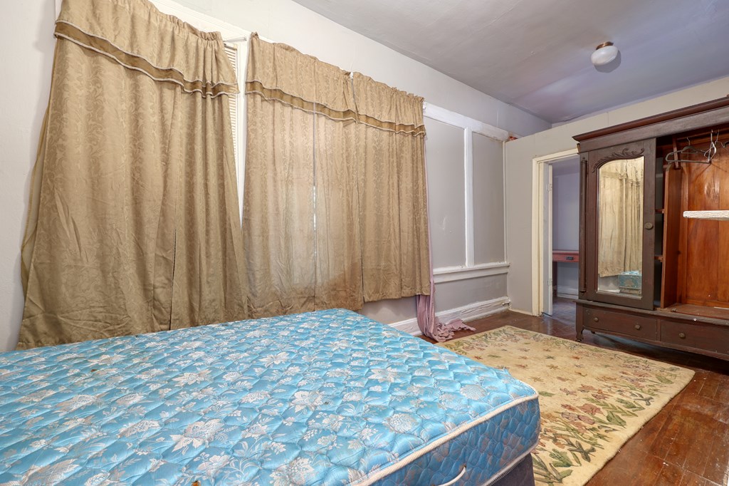 1641 16th Avenue Columbus, GA 31901 - Photo 35 of 76 a bedroom with a bed and a mirror