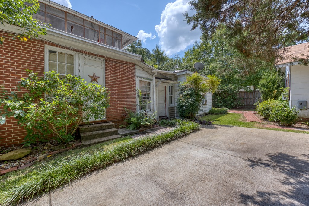 1641 16th Avenue Columbus, GA 31901 - Photo 50 of 76 a front view of a house with a yard and a garden