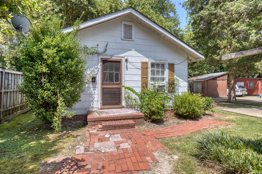 1641 16th Avenue Columbus, GA 31901 - Photo 7 of 76 a front view of a house with a yard and potted plants