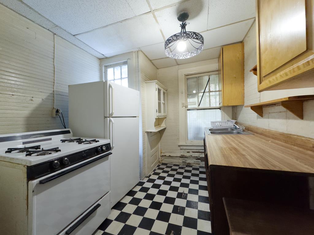 1641 16th Avenue Columbus, GA 31901 - Photo 66 of 76 a kitchen with a refrigerator and a stove top oven