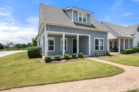 a front view of a house with garden