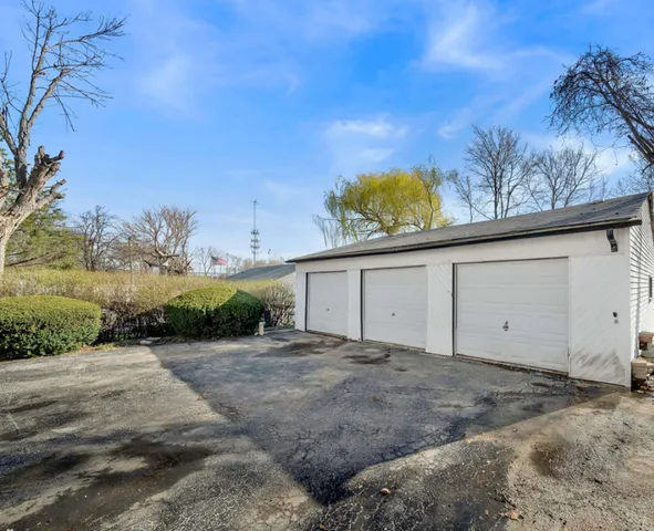 a view of a dry yard with wooden fence
