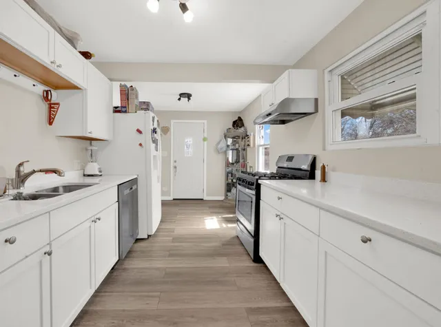 a kitchen with cabinets and window