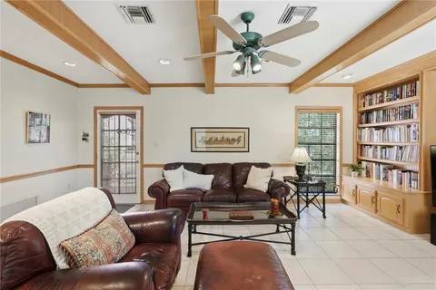 a living room with furniture and a book shelf