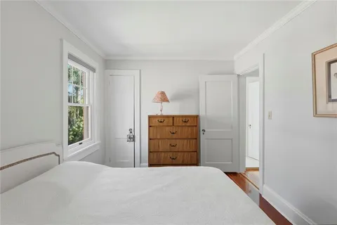 a view of kitchen with refrigerator and white cabinets