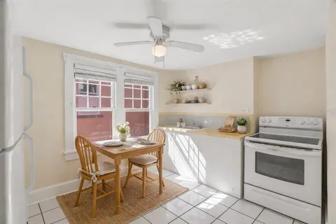 a kitchen with a stove a table and chairs