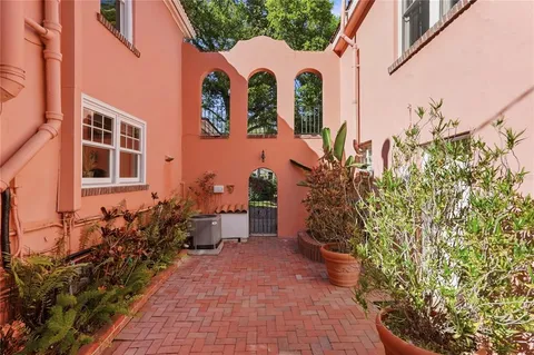 a backyard of a house with table and chairs