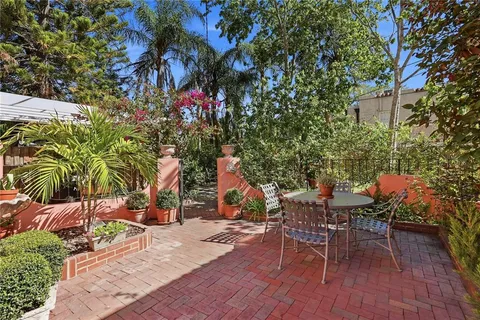 a backyard of a house with a table and chairs