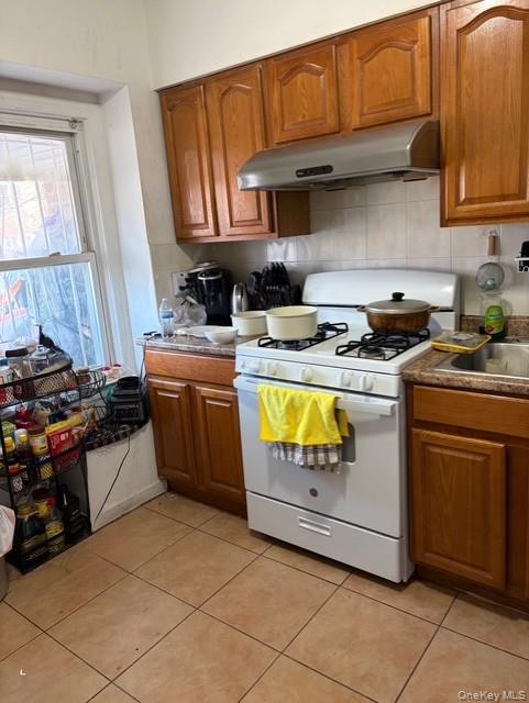 75-08 169th Street Queens, NY 11366 - Photo 3 of 13 a kitchen with stainless steel appliances granite countertop a stove and a sink