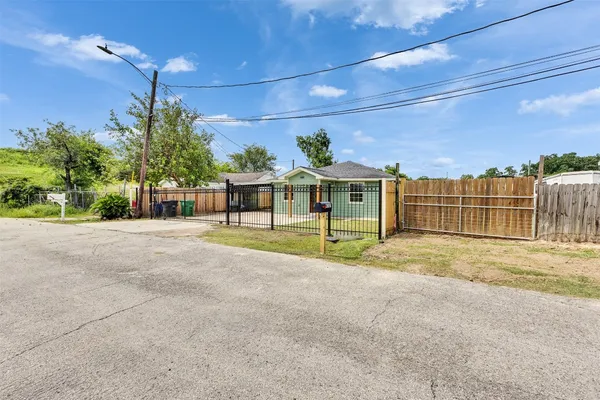 a view of a house with a backyard and a garage
