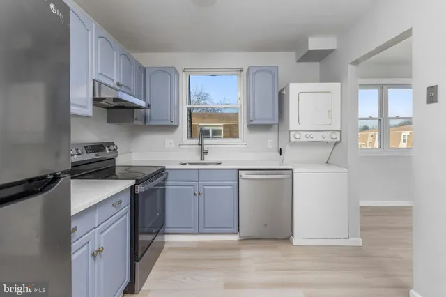 a kitchen with stainless steel appliances granite countertop a sink stove and cabinets
