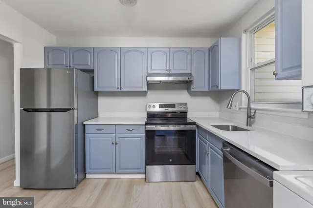 a kitchen with a sink stove and refrigerator