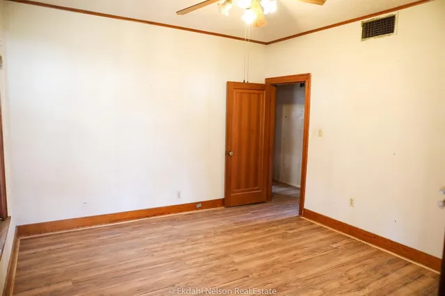 a view of a room with wooden floor and bedroom