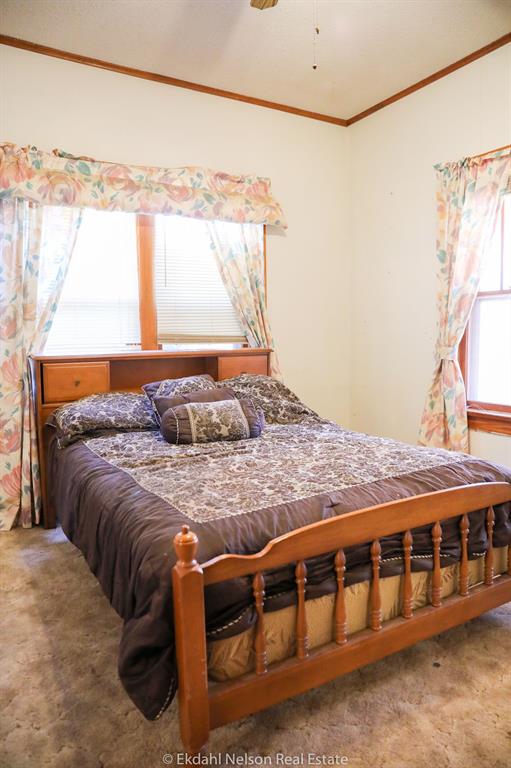 411 North McKinley Avenue Rotan, TX 79546 - Photo 8 of 25 a bed sitting in a bedroom next to a window