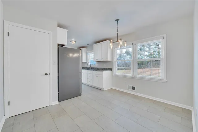 a kitchen with stainless steel appliances a refrigerator sink and cabinets