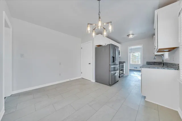 a view of a kitchen with a sink and refrigerator