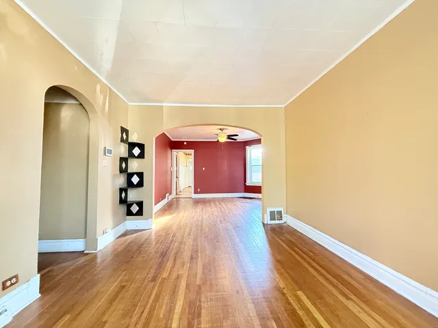 a view of a hallway with wooden floor