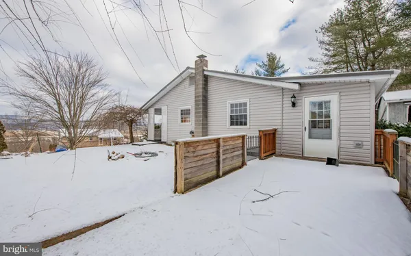 a view of a house with a yard covered in snow