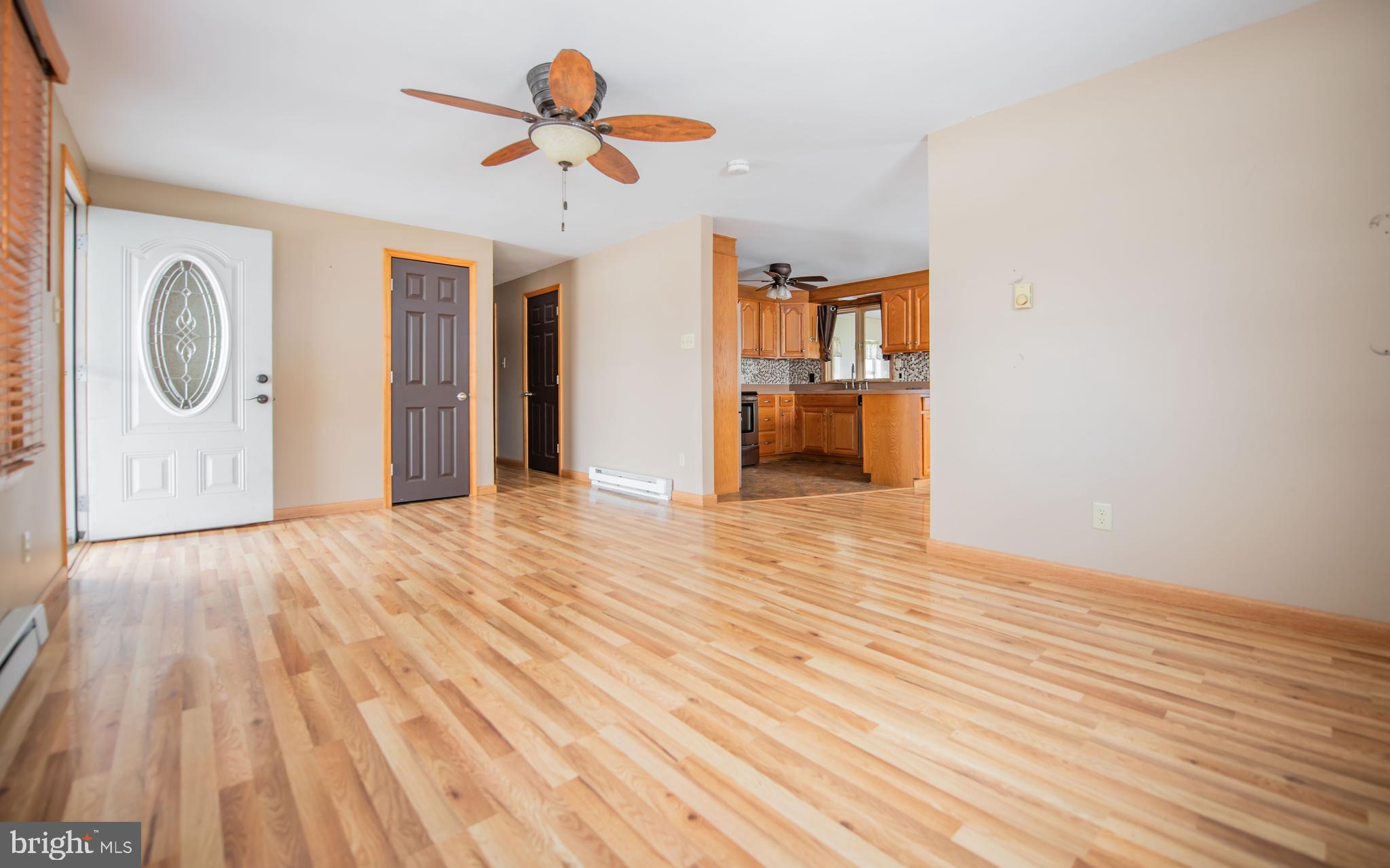 507 Grape Street Lock Haven, PA 17745 - Photo 3 of 26 a view of an empty room with wooden floor and a ceiling fan