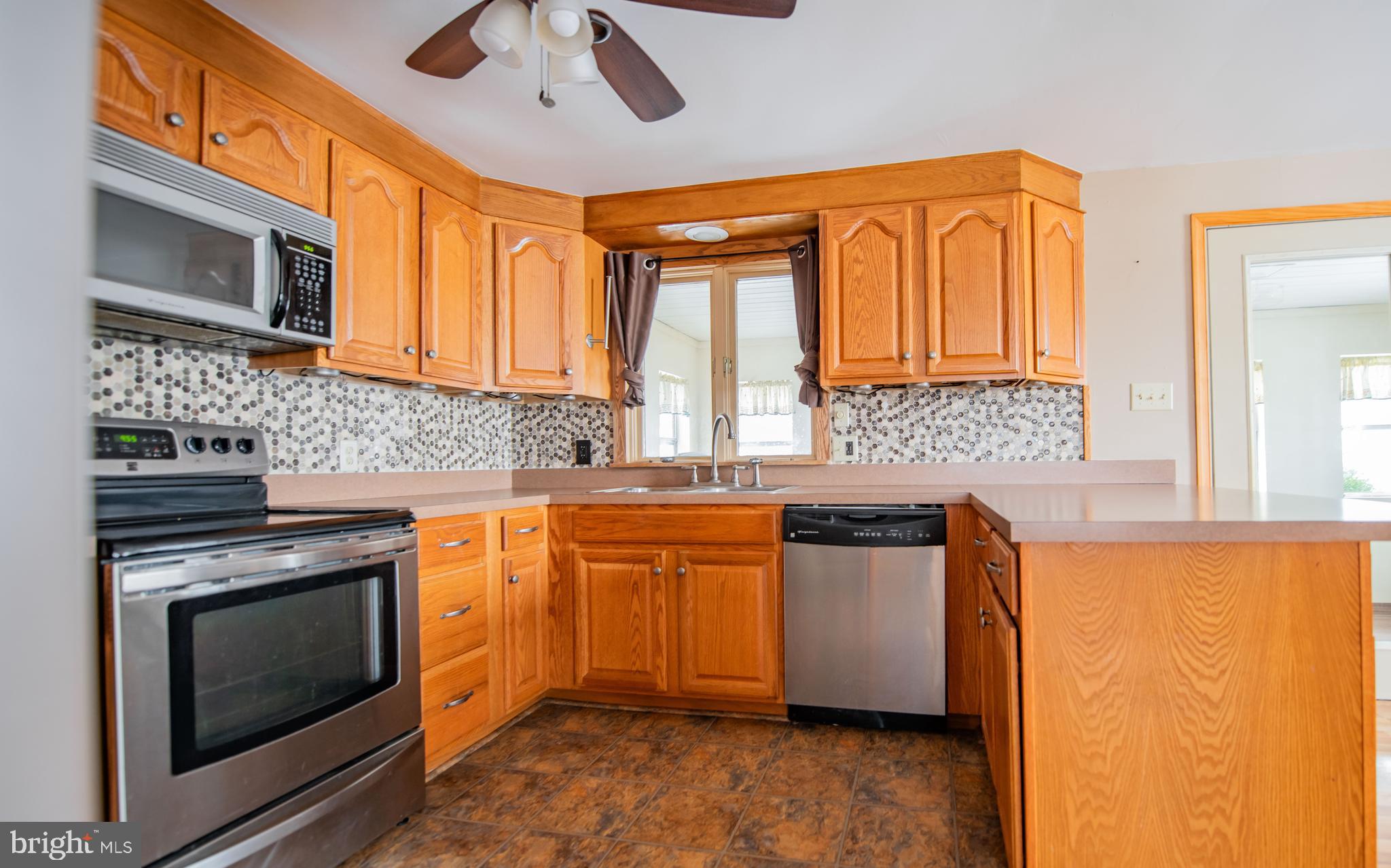 507 Grape Street Lock Haven, PA 17745 - Photo 5 of 26 a kitchen with stainless steel appliances granite countertop wooden cabinets and a stove top oven