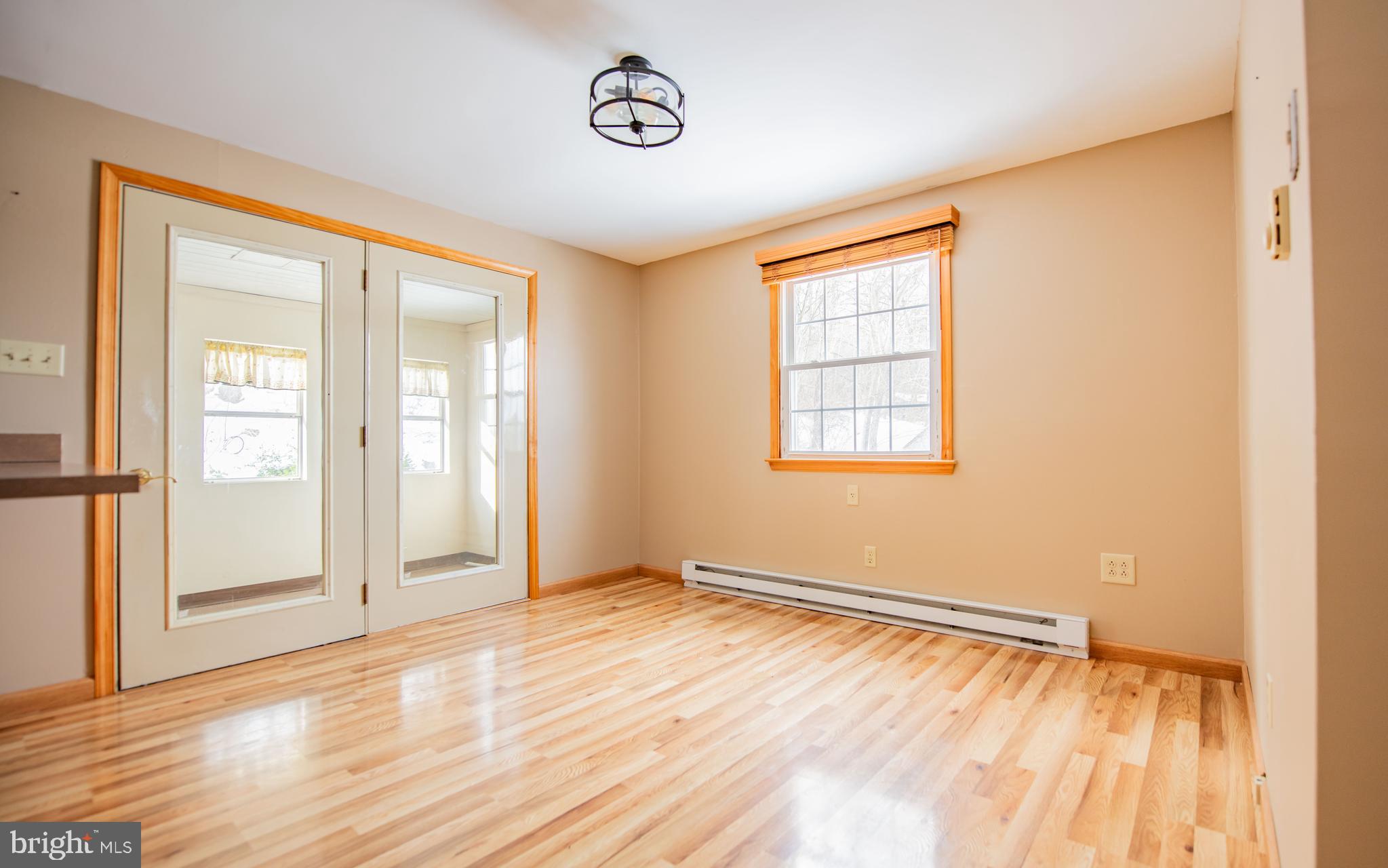 507 Grape Street Lock Haven, PA 17745 - Photo 7 of 26 an empty room with wooden floor and windows