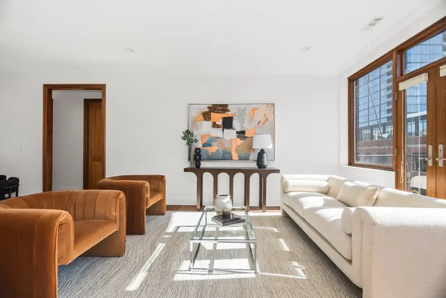 a living room with furniture a fireplace and a large window