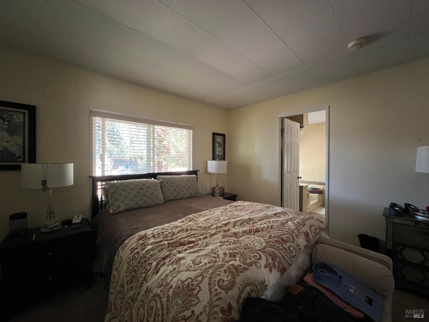 161 Bear Flag Road Sonoma, CA 95476 - Photo 17 of 57 a bed sitting in a bedroom next to a window