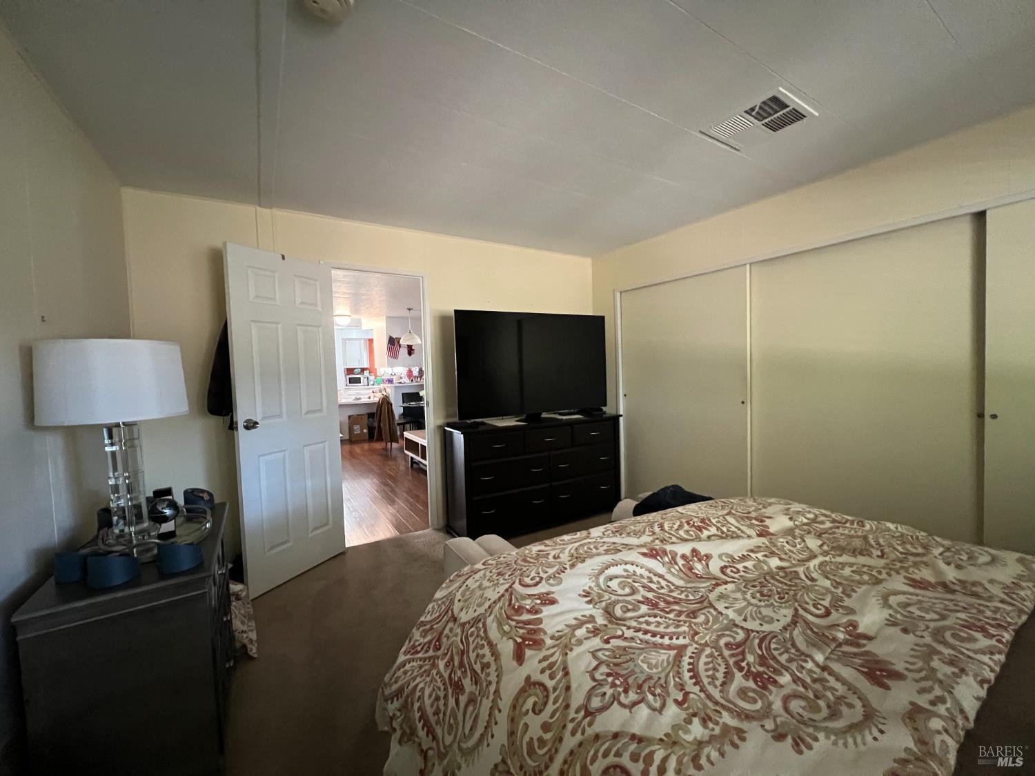 161 Bear Flag Road Sonoma, CA 95476 - Photo 18 of 57 a bedroom with a bed and a flat screen tv