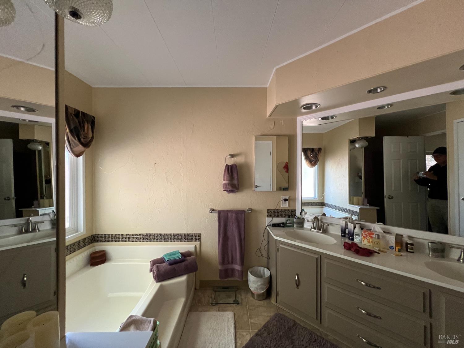 161 Bear Flag Road Sonoma, CA 95476 - Photo 19 of 57 a bathroom with a tub sink and mirror